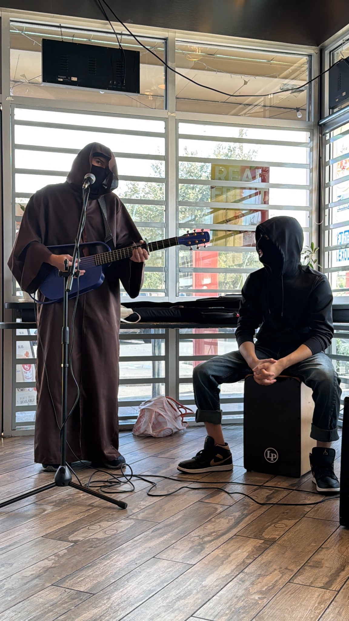 Fever Dream: Nibiru performing at Teahouse with acoustic guitar and cajon accompaniment